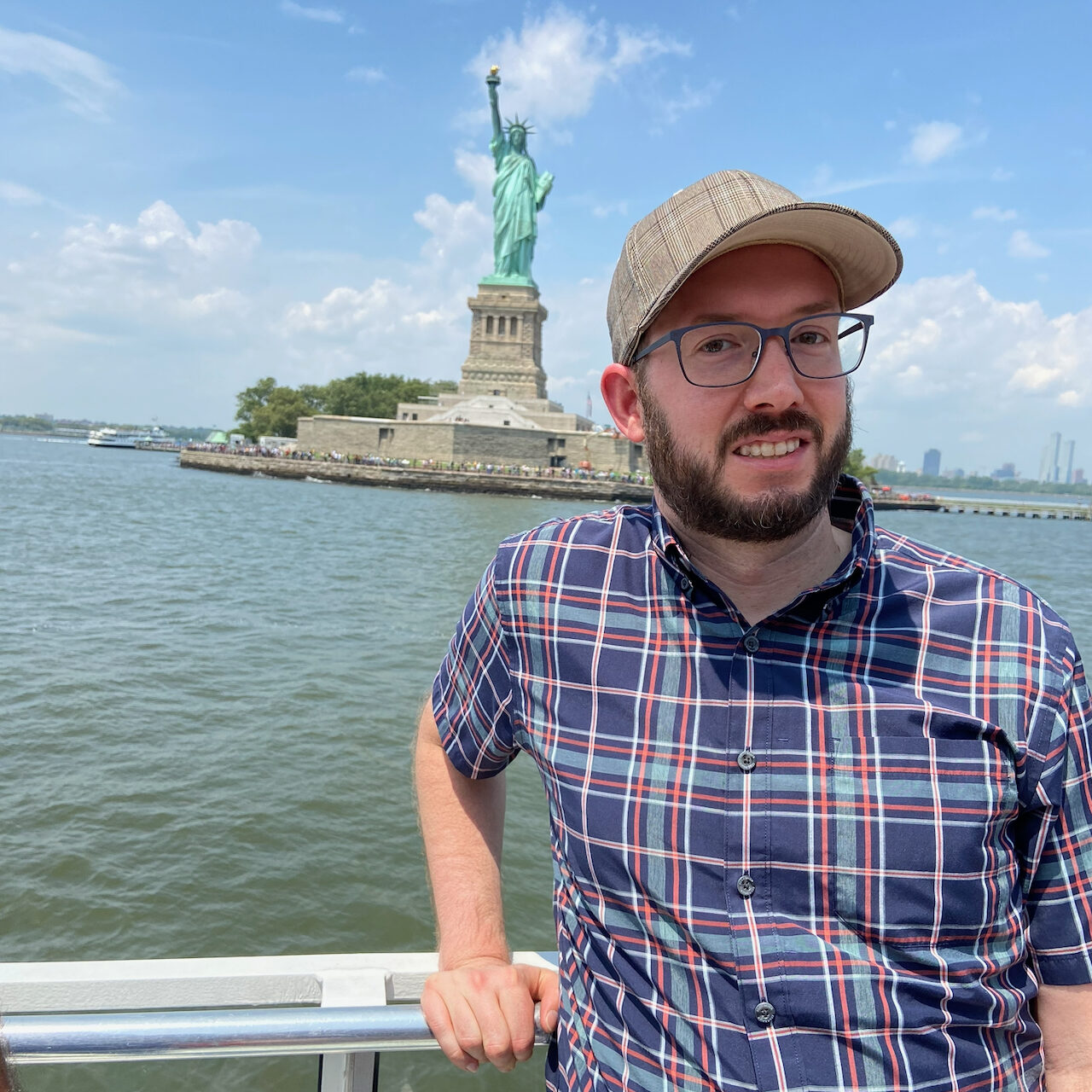 Calvin Freitas on a boat near the Statue of Liberty in New York Harbor